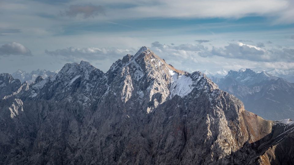 From Munich: Zugspitze Mountain Van Tour with Garmisch Town - Zugspitze: Germany’s highest peak and the border-at-the-top twist